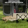 A dog is jumping out of a wagon next to a tent, with a woman sitting inside the tent. Produktbild-Vorschau