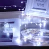 A string of white LED lights is draped over an open book and a picture frame. Produktbild-Vorschau