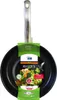 A black frying pan with a silver handle is shown against a white background. The pan has a green and white label attached to it, featuring images of vegetables and text. Produktbild-Vorschau