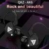 A marketing image featuring two black QKZ AK6 earphones with a white triangular logo on a dark, abstract background with purple accents. Produktbild-Vorschau