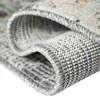 A close-up view of a rolled-up rug, showing the texture and edge binding. Podgląd zdjęcia produktu