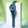 A teal Casio G-Shock watch is displayed on a white pedestal against a light green background. Produktbild-Vorschau