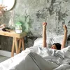 A person waking up in bed next to an aroma diffuser. Voir les images du produit