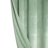 A close-up view of a green velour curtain, with a portion pulled back to reveal the texture and folds. Podgląd zdjęcia produktu