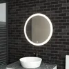 A modern bathroom vanity with a round LED mirror above a vessel sink. Voir les images du produit