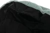A close-up view of a black zippered pocket on a light blue fuzzy fabric. Náhľad obrázku produktu