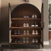 A shoe cabinet with multiple shelves filled with shoes. Produktbild-Vorschau