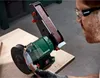 A person is using a belt sander and grinding wheel machine in a workshop. Produktbild-Vorschau