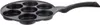 A black frying pan with 7 circular indentations for cooking eggs or other small items, shown from a diagonal angle against a white background. Náhled obrázku produktu