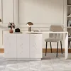 A white L-shaped desk with a chair and a laptop on it, set against a white paneled wall. Podgląd zdjęcia produktu