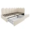 A beige upholstered bed frame with two open drawers underneath, shown from a diagonal angle. Anteprima dell’immagine prodotto