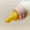 Close-up of a baby bottle nipple with milk dripping. Voir les images du produit