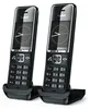 Two black cordless phones are shown in their charging cradles against a white background. Anteprima dell’immagine prodotto