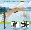 An outdoor patio umbrella shown in a natural setting with a lake and mountains in the background. The image highlights the umbrella's adjustable features and rotation capabilities. Podgląd zdjęcia produktu