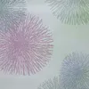A close-up view of a fabric with a repeating pattern of stylized dandelion seed heads or fireworks. Produktbild-Vorschau