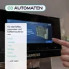 A hand is shown touching a screen on a coffee machine, with a menu of brands displayed. Produktbild-Vorschau