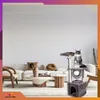A cat is sitting on a cat tree in a modern living room with a sofa and coffee table. Náhľad obrázku produktu