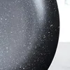 A close-up view of the speckled surface of a black frying pan. Náhľad obrázku produktu