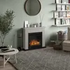 A cozy living room scene featuring an electric fireplace, a round mirror, bookshelves, and a coffee table. Produktbild-Vorschau