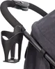 Close-up of a stroller handle with a cup holder attached. Produktbild-Vorschau
