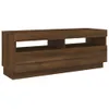 A brown wooden TV stand with two open shelves and a drawer. Náhled obrázku produktu