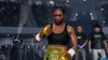 A female boxer in gold gloves and green shorts stands in a boxing ring, facing the camera. Spectators are visible in the background. Produktbild-Vorschau