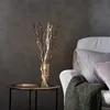 A decorative vase with LED lights on a side table next to a sofa. Podgląd zdjęcia produktu