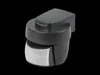 A dark grey motion sensor with a white sensor lens, set against a black background. Produktbild-Vorschau