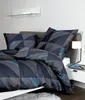 A neatly made bed with a geometric patterned duvet cover and pillows. Produktbild-Vorschau