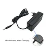 A black power adapter with a cord and a close-up inset showing an illuminated green LED indicator. Podgląd zdjęcia produktu