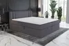 A dark gray boxspring bed with a mattress and topper is shown in a modern bedroom setting. Produktbild-Vorschau