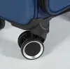 Close-up of the wheels and bottom corner of a blue suitcase. Produktbild-Vorschau