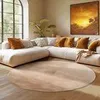 A modern living room with a large sectional sofa and a round rug. Podgląd zdjęcia produktu