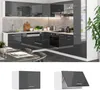 A modern, high-gloss kitchen with dark grey cabinets and white accents, featuring integrated appliances and a concrete-look backsplash. Náhled obrázku produktu
