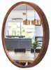 A mirror reflecting a dining and living area with furniture and pendant lights. Produktbild-Vorschau
