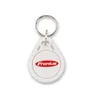 A white key fob with a red logo is shown. Produktbild-Vorschau