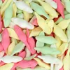 A close-up, overhead view of a pile of colorful gummy candies. Produktbild-Vorschau