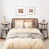 A bedroom scene with a bed, nightstands, and artwork. Podgląd zdjęcia produktu