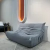 A modern living room with a grey sofa and a unique wall light. Anteprima dell’immagine prodotto