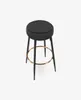 A black bar stool with a gold footrest on a white background. Podgląd zdjęcia produktu