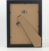 The back of a black picture frame with a stand attached. Produktbild-Vorschau