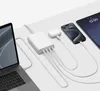 A white multi-port charging station is shown connected to a laptop, smartphone, tablet, and wireless earbuds. Voir les images du produit