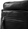 A close-up shot of a black leather bag, focusing on the zipper and embossed brand name. Anteprima dell’immagine prodotto