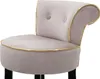 A close-up view of a gray upholstered stool with gold trim. Podgląd zdjęcia produktu