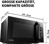 A black Toshiba microwave oven with dimensions indicated by lines and text. Produktbild-Vorschau