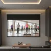 A home theater room with a large projector screen displaying an aerobics class. Produktbild-Vorschau