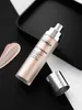 A bottle of Filorga Lift-Structure Ultra-Lifting Rosy-Glow Fluid is placed on a black and white surface, with a swatch of the product next to it. The cap is off and placed nearby. Voir les images du produit
