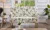 A floral patterned sofa is placed in a well-lit room with a window in the background. Produktbild-Vorschau
