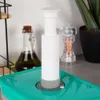 A vacuum pump sits on top of a teal container, with a bottle of olive oil and a salt grinder in the background. Náhľad obrázku produktu