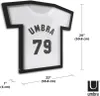 A black t-shirt shaped frame displaying a white t-shirt with the text "UMBRA 79" printed on it. Dimensions are shown with measurement lines and text. Náhled obrázku produktu